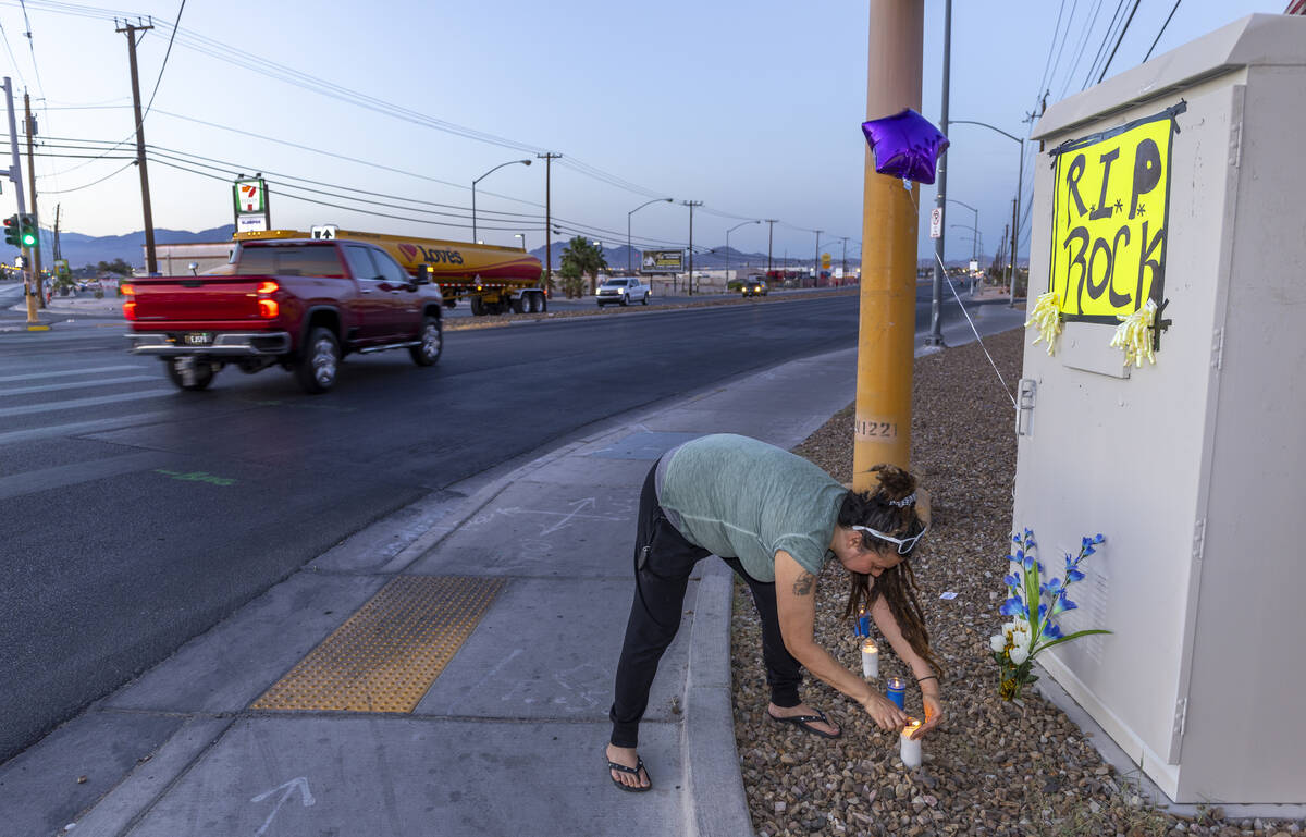 Melani Holliday lights candles at a small vigil for a beloved transient man, Kevin Wayne Willia ...