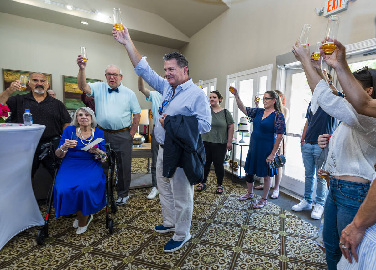 Son Mark Lewis-Jones, center right, gives a toast to the newly married bride Carolyn Brylinski, ...