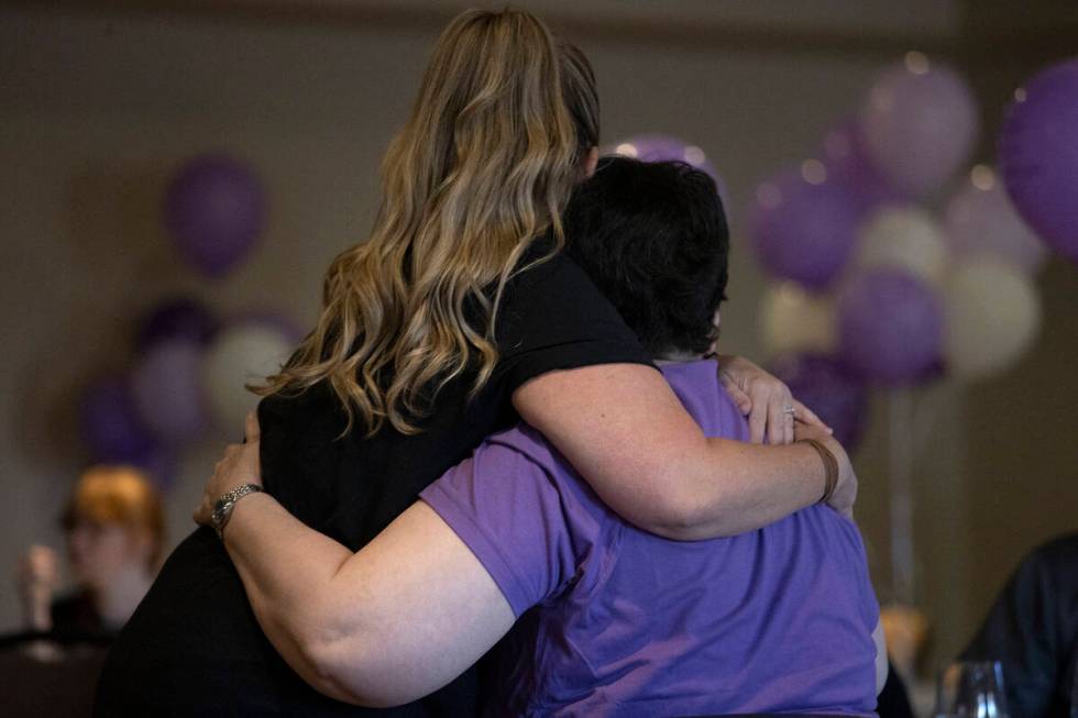 Angelena Fisher hugs Judy Booth, Tiffany Booth’s mother, during a memorial service for T ...