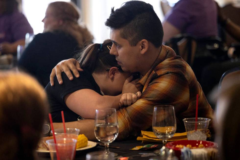 Cailin Hickson, a cousin of Tiffany Booth, hugs her fiancé Luis Munoz during a memorial se ...