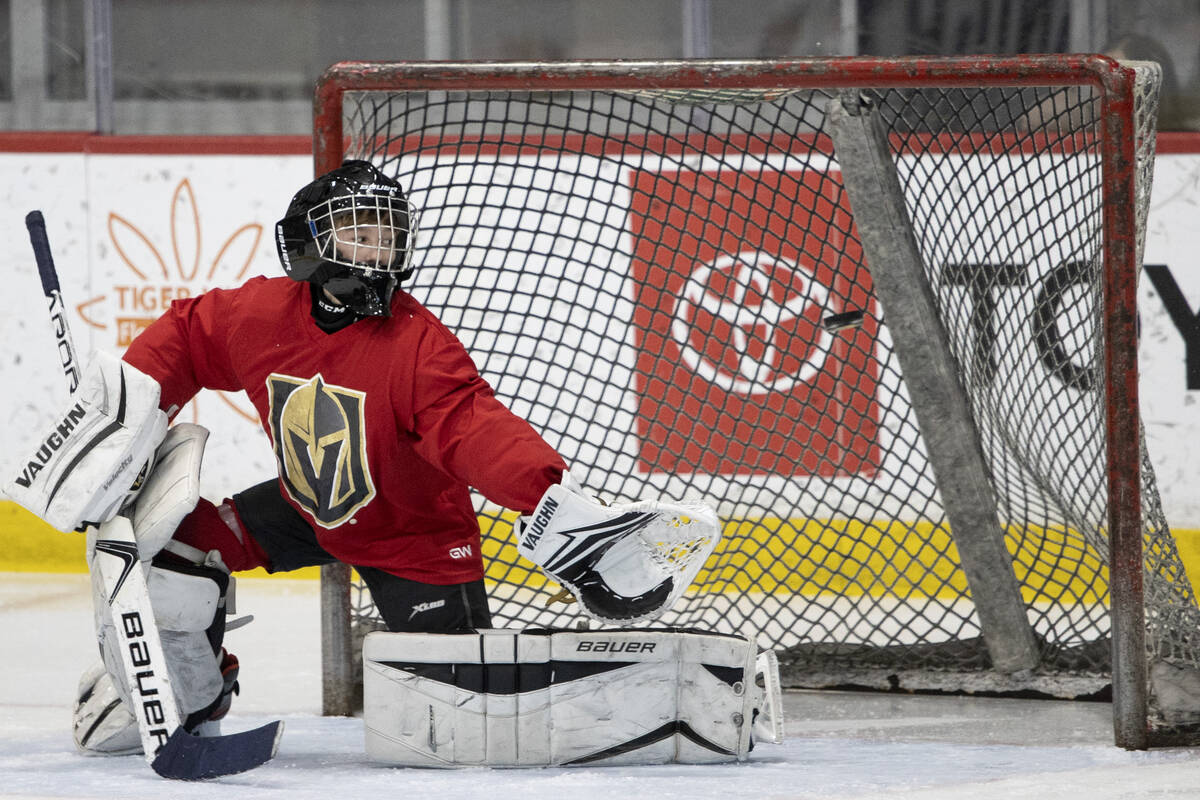 Red Raptors goaltender Sonny Batdorf attempts to save a goal shot by the Miners during a 14U Jr ...