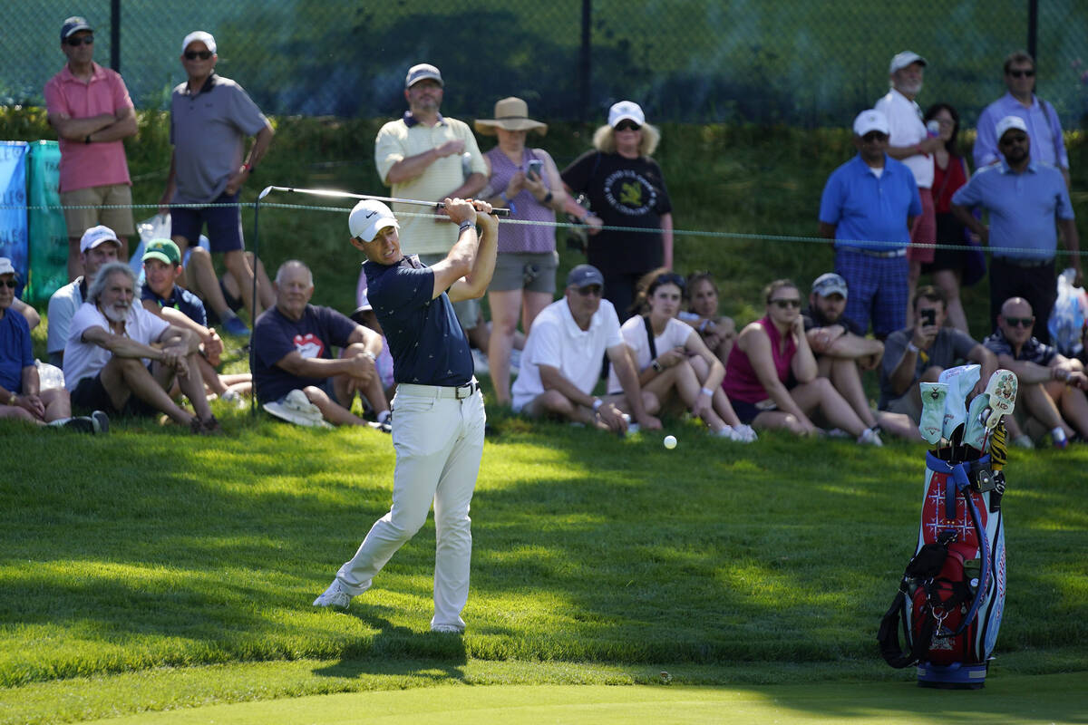 Rory McIlroy, of Northern Ireland, hits onto the green at the fourth hole at The Country Club, ...