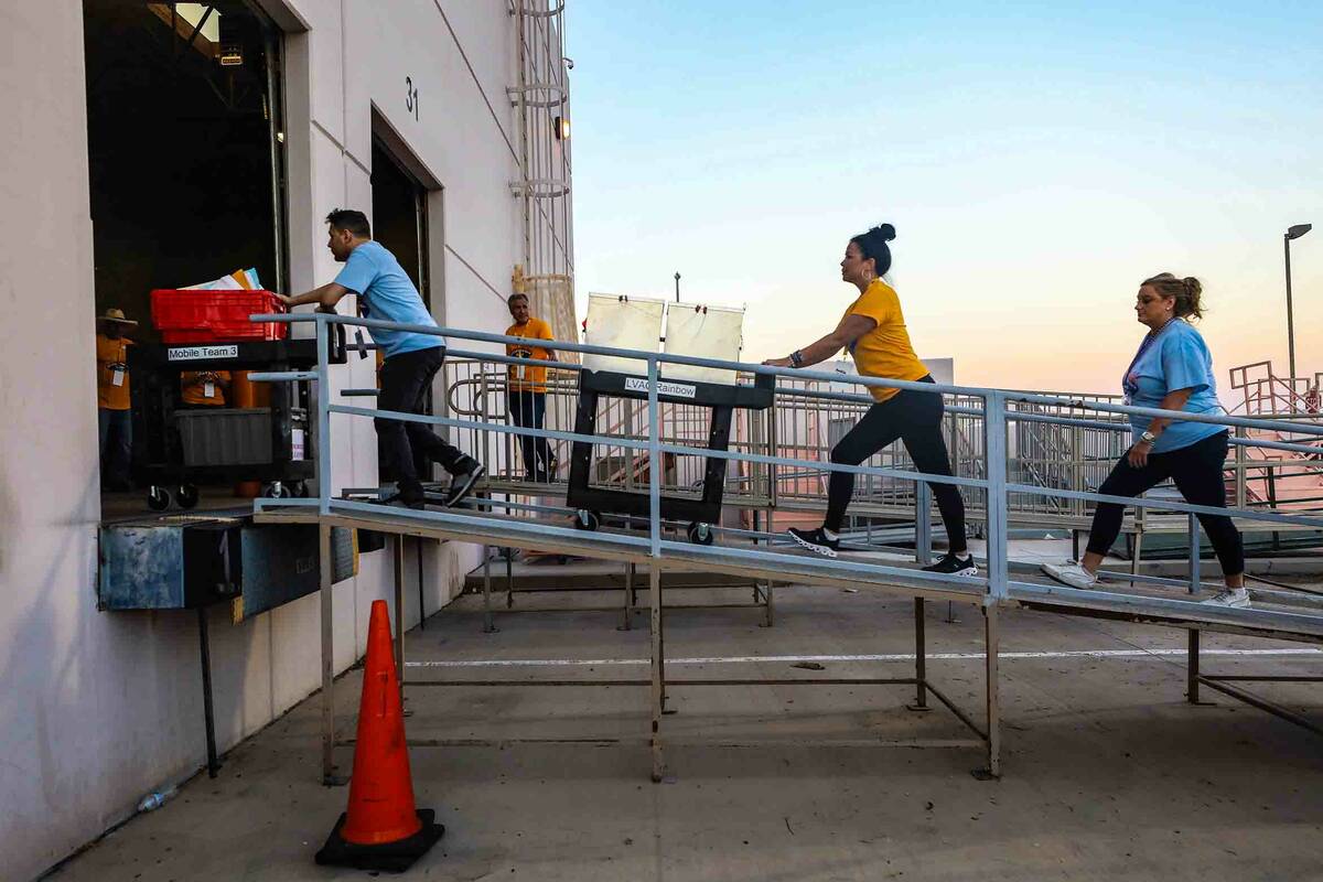 Election workers haul the first batch of ballot boxes for the primary election into the Clark C ...