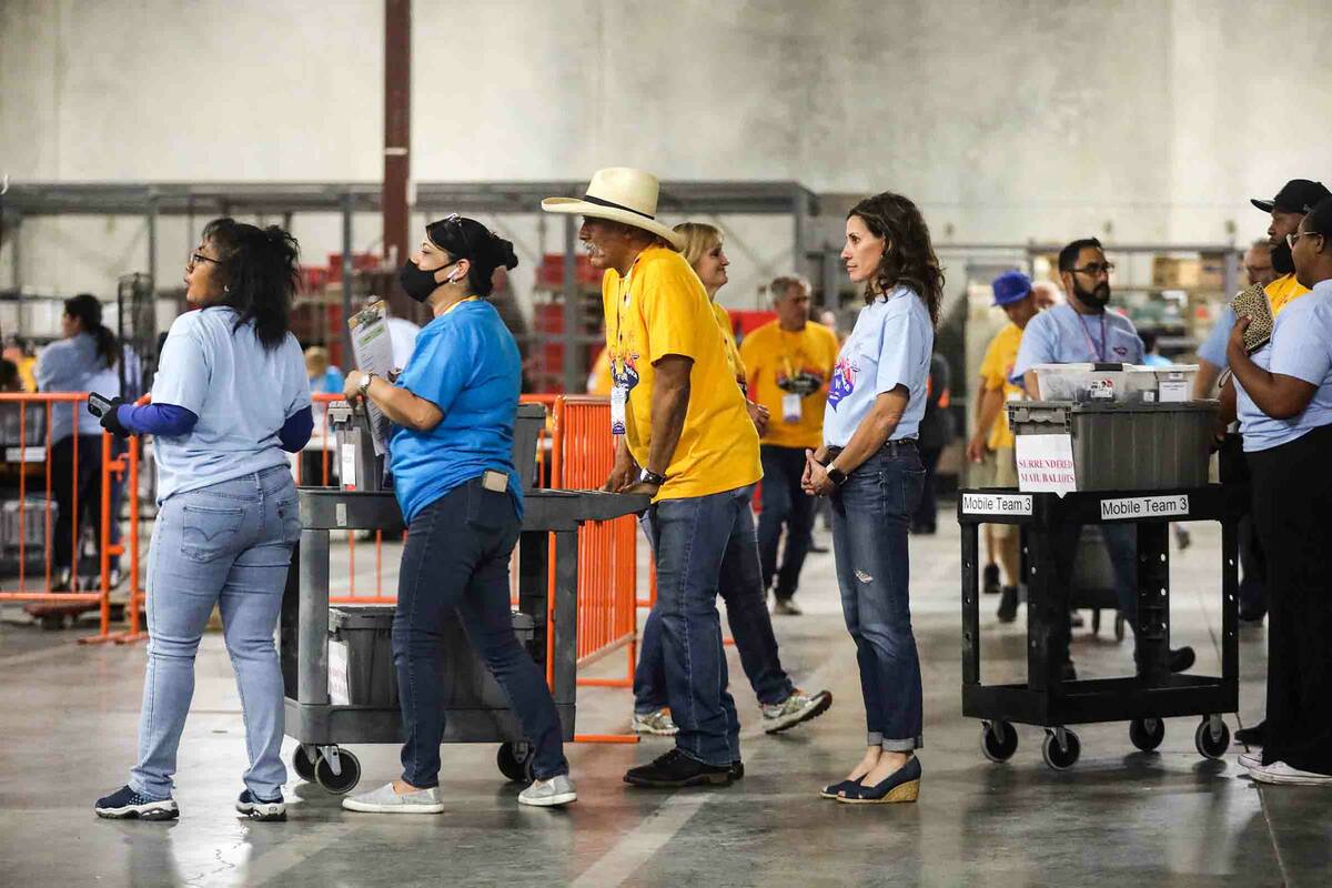 Election workers carry in boxes of ballots to the Clark County Election Department in North Las ...