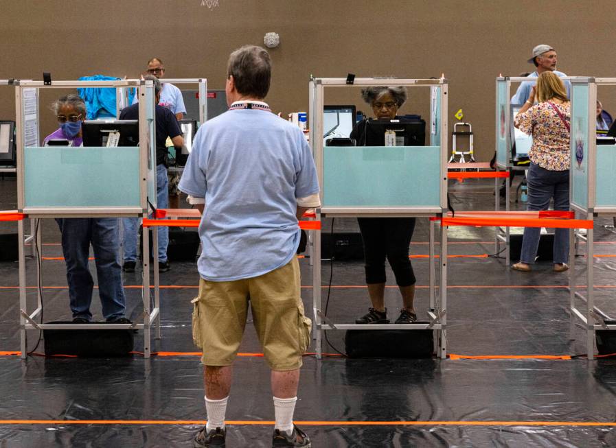 Voters cast their ballots at a polling station at Desert Breeze Community Center on Tuesday, Ju ...