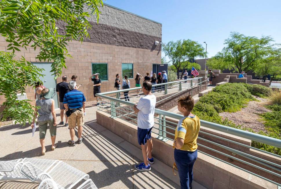 People line up for their turns to vote for the Nevada primary election at Veterans Memorial Lei ...