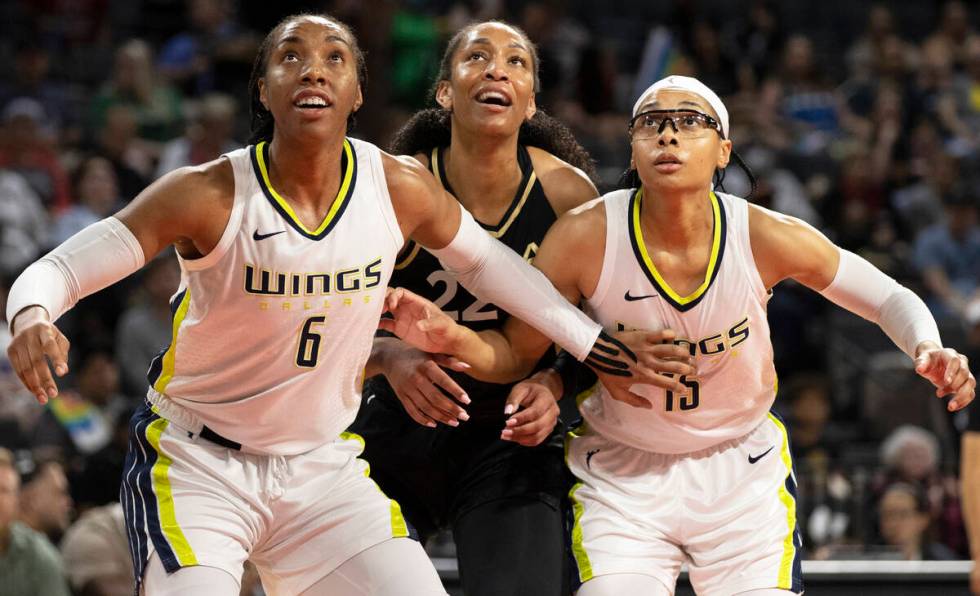 Aces forward A'ja Wilson (22) fights for a rebound with Dallas Wings forward Kayla Thornton (6) ...