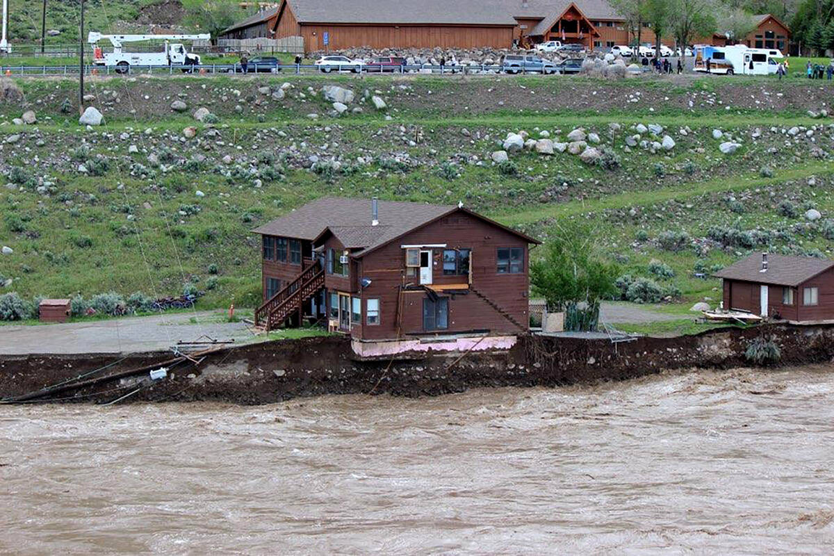 In this image provided by Sam Glotzbach, the flooding Yellowstone River undercuts the river ban ...