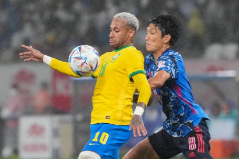 Neymar of Brazil, left, fights for the ball against Genki Haraguchi of Japan during a friendly ...