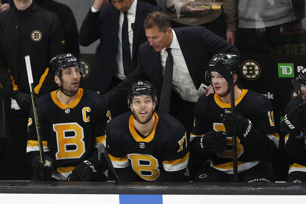 Boston Bruins head coach Bruce Cassidy, top center, congratulates Patrice Bergeron, left, and T ...