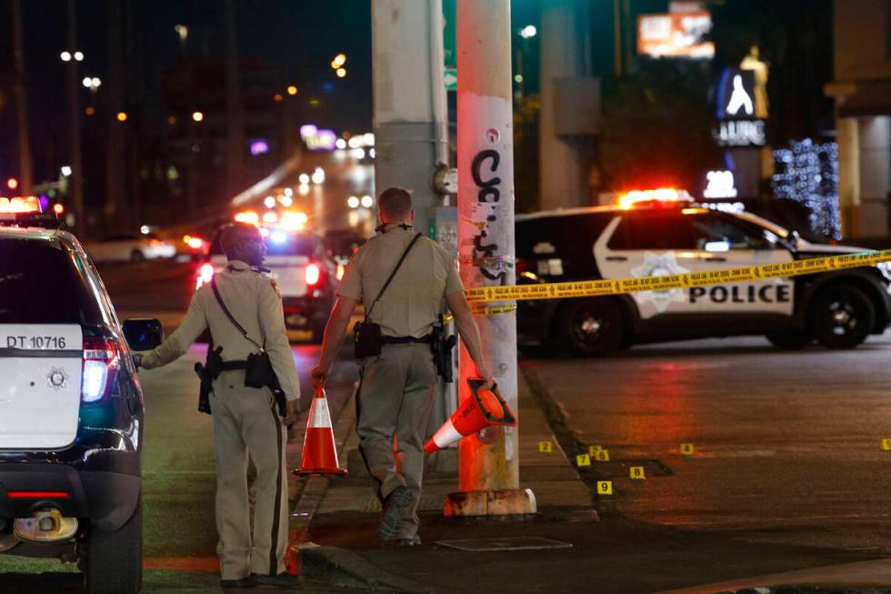 Las Vegas police investigate after a shooting near the intersection of Las Vegas Boulevard and ...