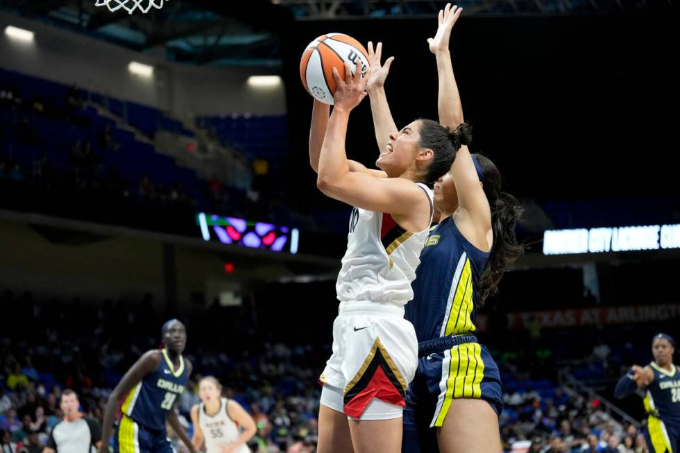 Kelsey Plum #10 of the Las Vegas Aces drives to the basket during the game against the Dallas W ...