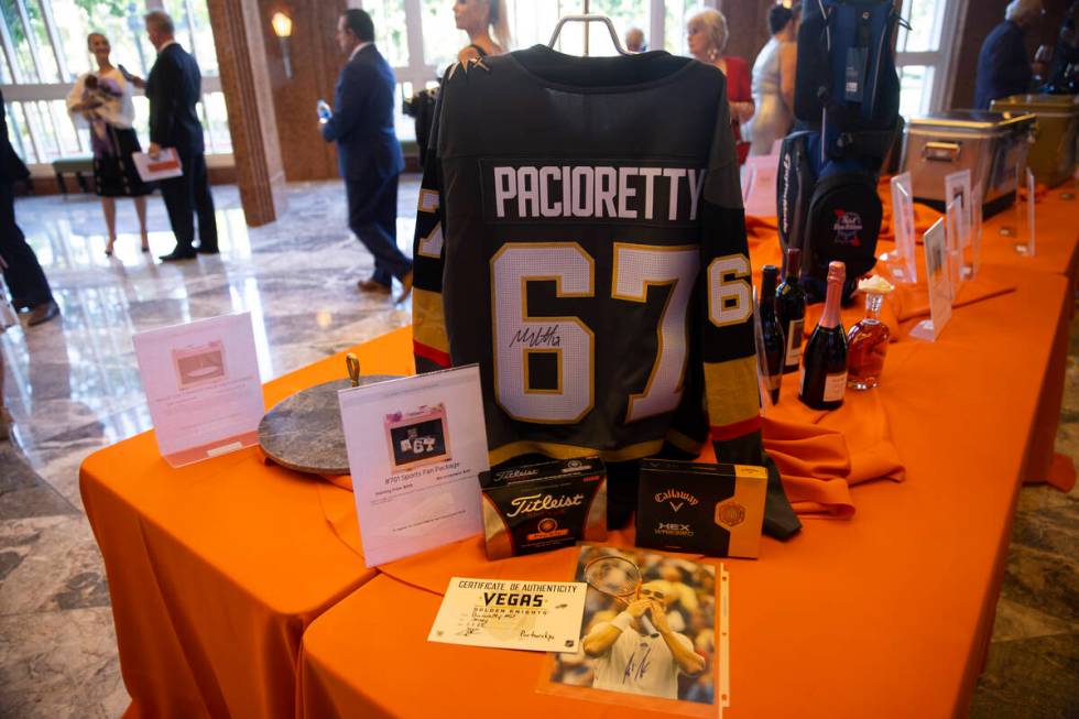 People browse the auction items during the Las Vegas Philharmonic’s fundraising event at ...