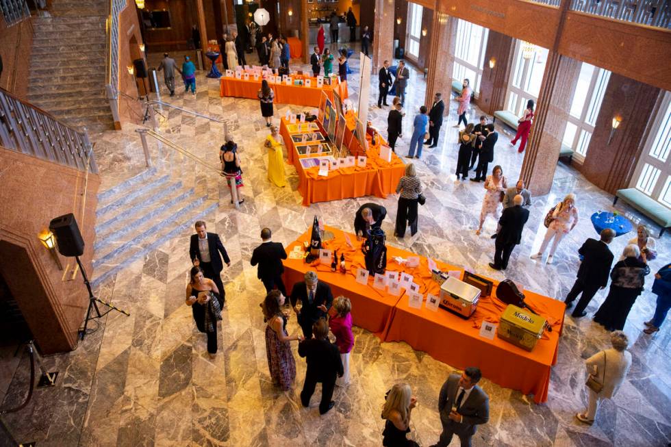 People browse the auction items during the Las Vegas Philharmonic’s fundraising event at ...