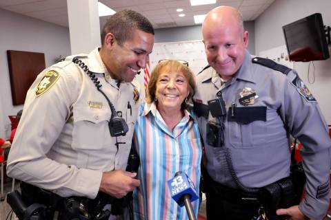 Jean Dahlberg thanks Las Vegas police officer Brandon Alvarado, left, and Nevada State Police T ...