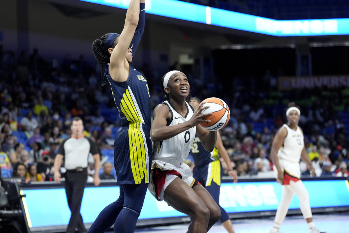 Jackie Young #0 of the Las Vegas Aces drives to the basket during the game against the Dallas W ...