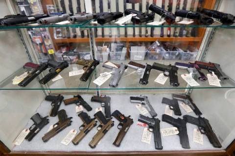 FILE - In this March 25, 2020, file photo semi-automatic handguns are displayed at shop in New ...
