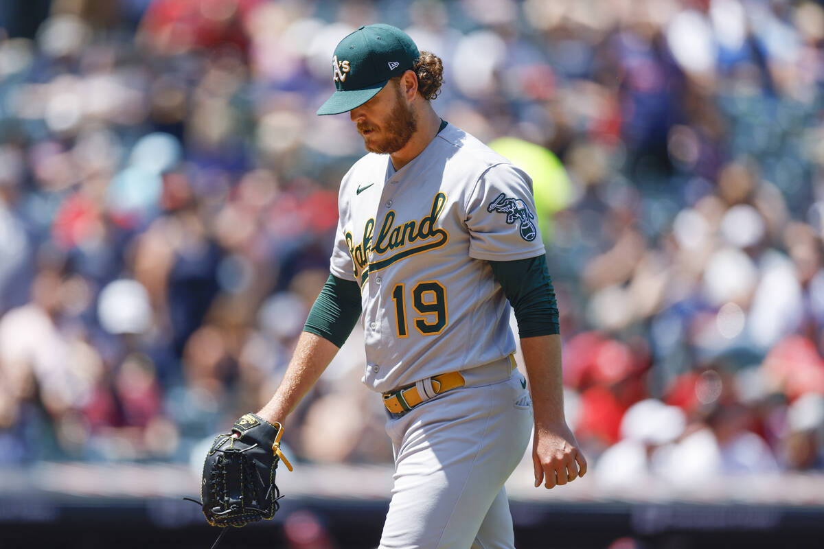 Oakland Athletics starting pitcher Cole Irvin walks off the field after being removed from the ...