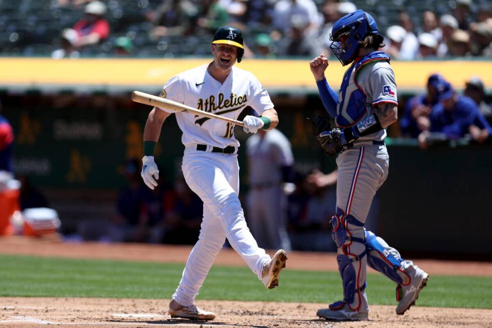 Oakland Athletics' Sean Murphy (12) reacts after striking out in front of Texas Rangers catcher ...