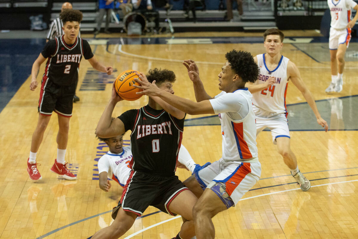 Bishop Gorman's Christopher Nwuli guards Liberty's Andre Porter during the NIAA Class 5A boys b ...