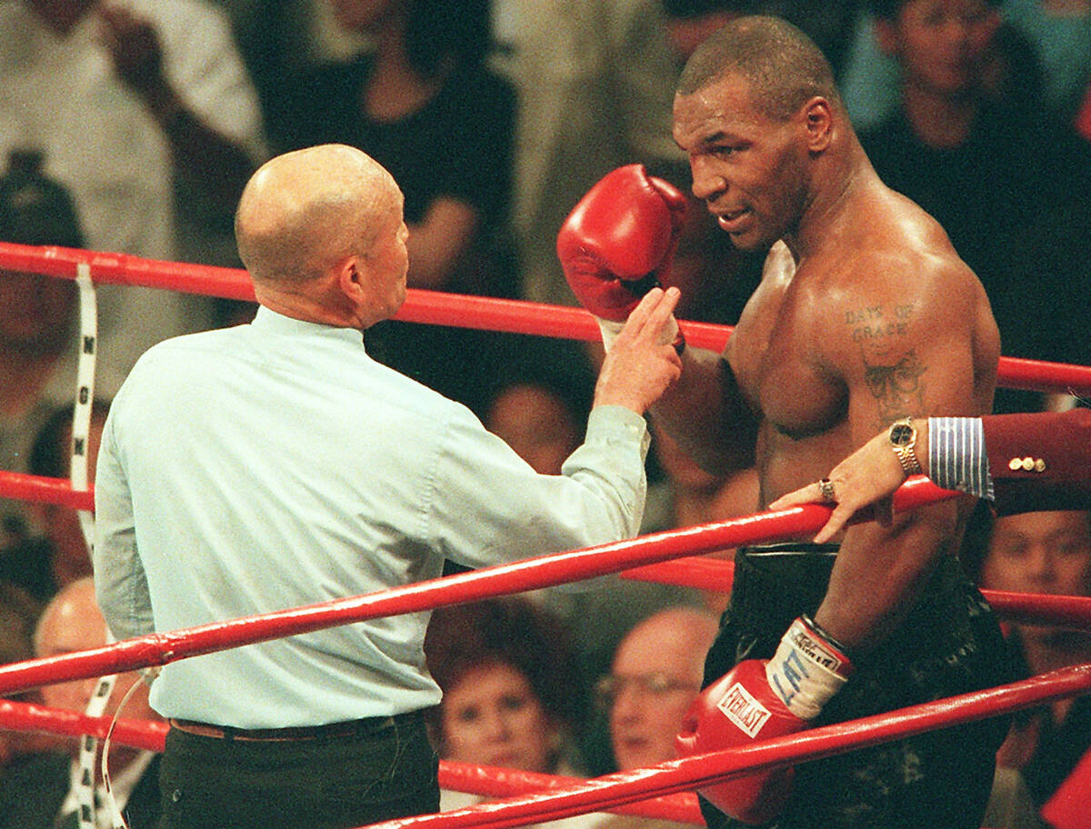 Referee Mills Lane warns boxer Mike Tyson after Tyson bit the ear of his opponent Evander Holyf ...