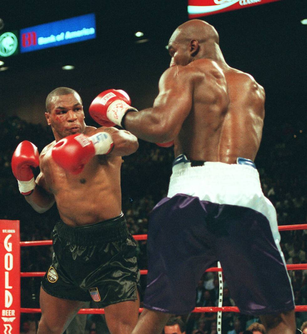 Mike Tyson bleeds from a head butt in the second round. Tyson has said it was the butt that mad ...