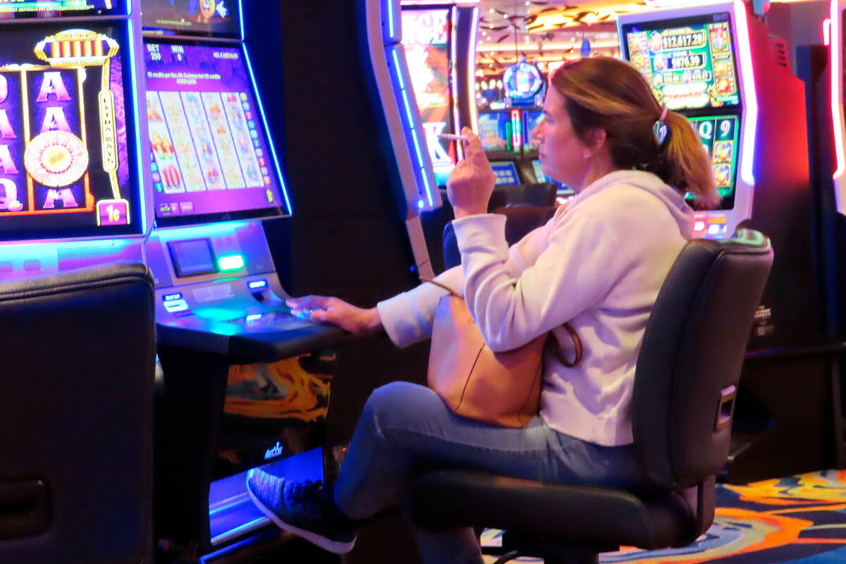 A woman smokes while playing a slot machine at the Ocean Casino Resort on Feb. 10, 2022, in Atl ...