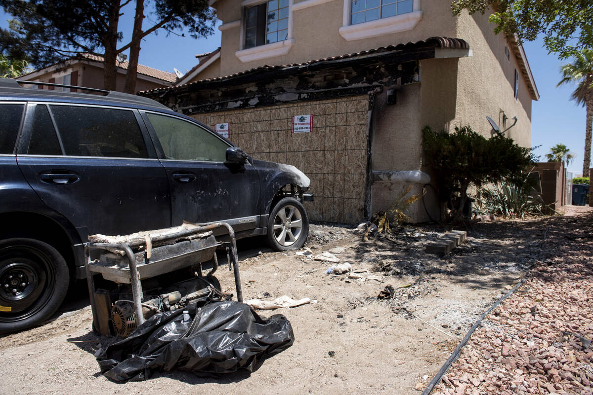 The remains of an overnight house fire at 3332 Crystal Tower Street that displaced 11 people on ...