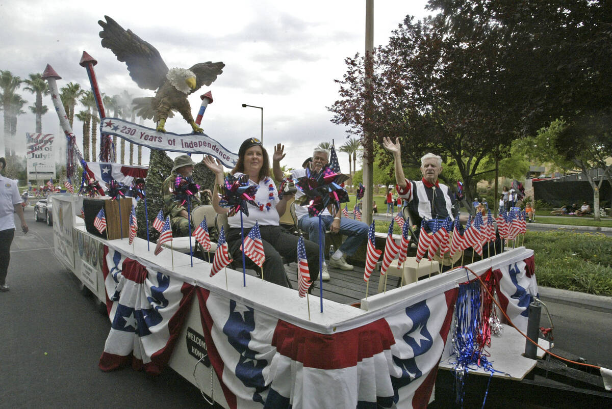 Members of The Vietnam Veterans of America wave from their float "Freedom Bird," as it rolls al ...