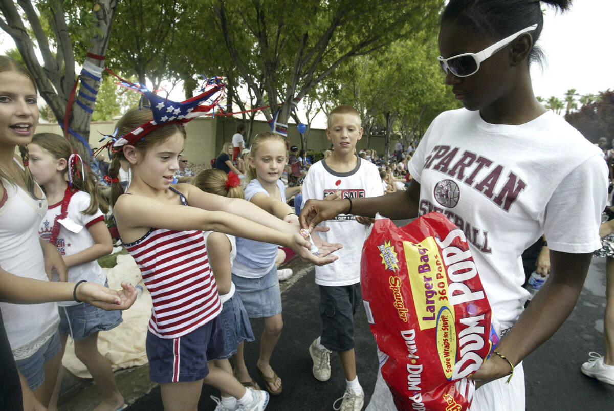 Cimarron Memorial High School student Aurelia Houston, 17, hands out candy to a group of an eag ...