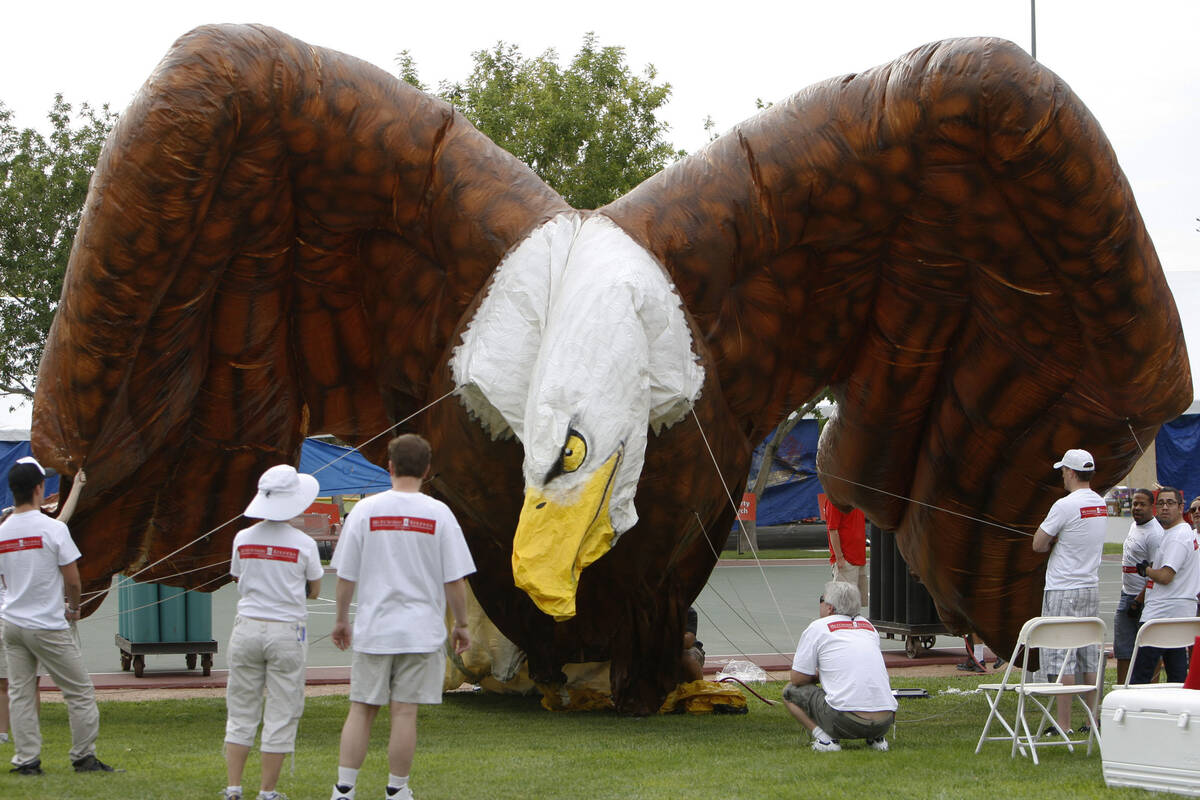 A large helium-filled eagle, sponsored by Hutchison & Steffen attorneys, takes shape in the sta ...