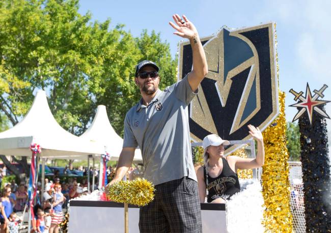 Golden Knights defenseman Deryk Engelland waves to cheering fans from the City National Bank an ...