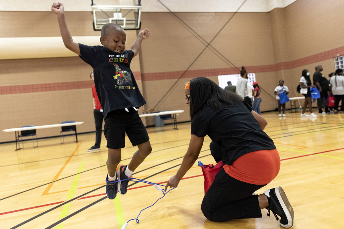 Cameron Carter, 5, jumps rope with his mother Diana Carter during a Juneteenth event at Whitney ...