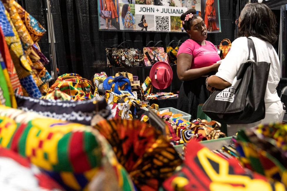 Eden Arunn, left, owner of John + Juliana, interacts with a customer during a Juneteenth expo a ...