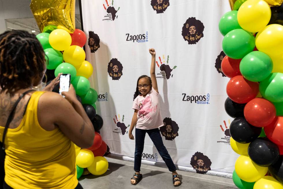 Mariah Moore poses for a photo taken by her mother, Lakesha Moore, during a Juneteenth expo at ...