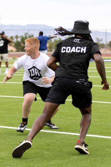 Raiders wide receiver Davante Adams runs a route against a young defender at his youth football ...