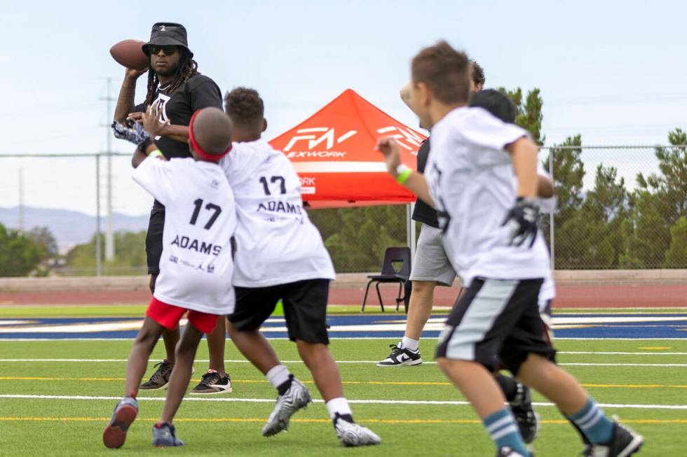 Raiders wide receiver Davante Adams throws the football at his youth football camp at Spring Va ...
