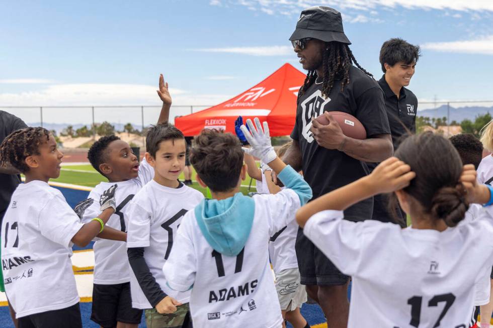 Raiders wide receiver Davante Adams coaches at his youth football camp at Spring Valley High Sc ...