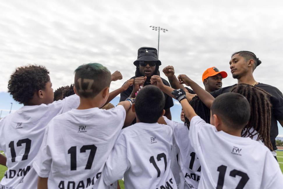 Raiders wide receiver Davante Adams coaches in the huddle at his youth football camp at Spring ...