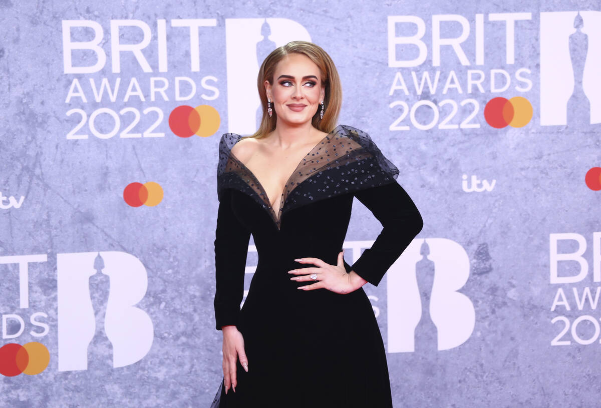 Adele poses for photographers upon arrival at the Brit Awards 2022 in London Tuesday, Feb. 8, 2 ...