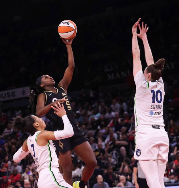 Las Vegas Aces guard Jackie Young (0) lays up the ball against Minnesota Lynx forwards Aerial P ...