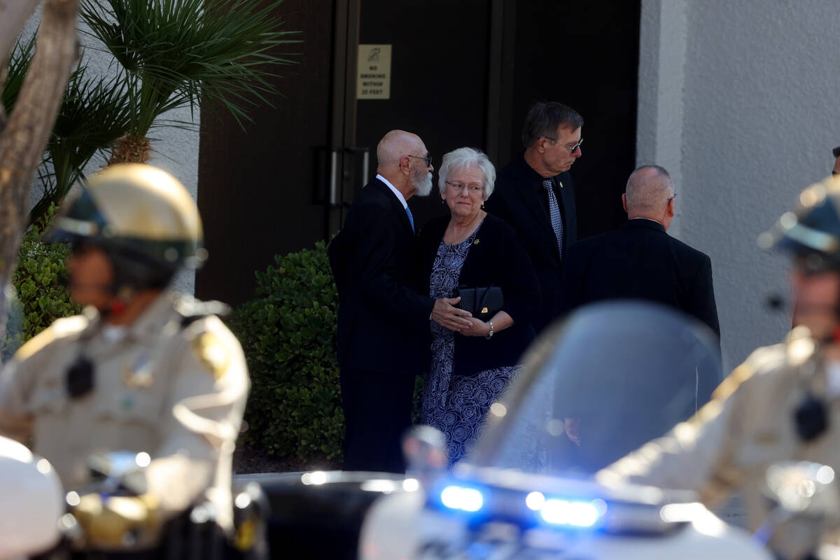 Family members of Las Vegas police Detective Justin Terry comfort each other at Palm Downtown M ...