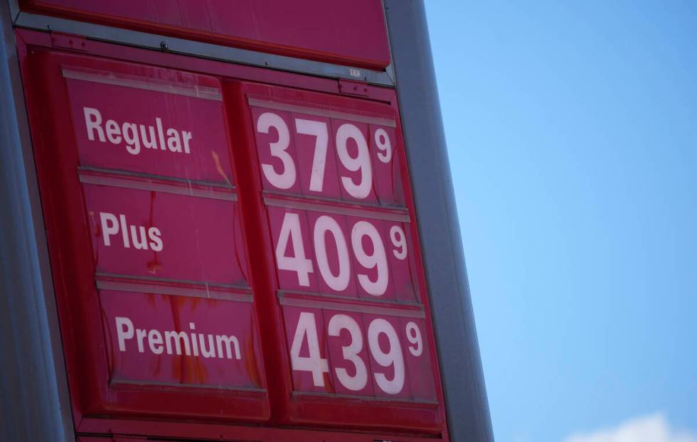 FILE - In this Oct. 24 2021, file photo, gas pump prices are posted on a sign at a Conoco stati ...