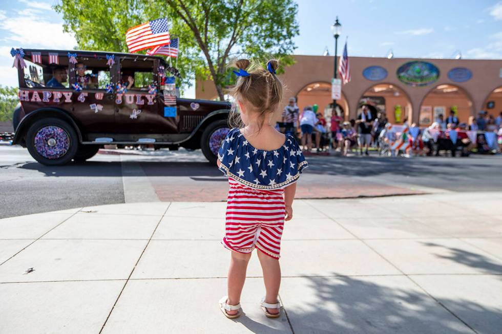 Olivia Ruecking watches as the parade passes down Nevada Way during the two-day Damboree event ...