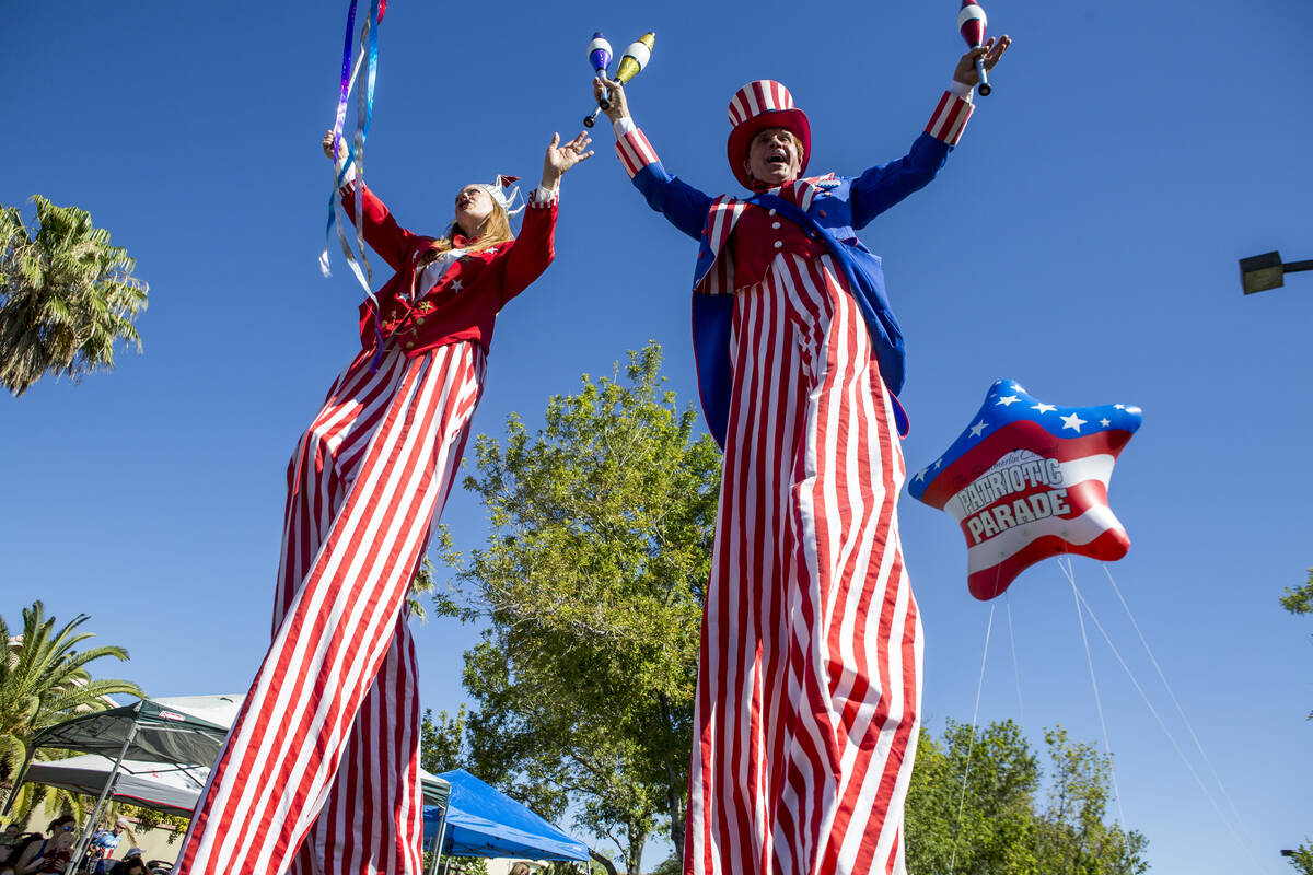 In this July 4, 2017, file photo, patriotic stilt walkers wave to crowds during the Summerlin C ...