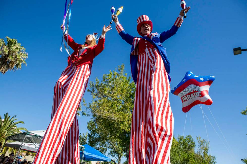 In this July 4, 2017, file photo, patriotic stilt walkers wave to crowds during the Summerlin C ...