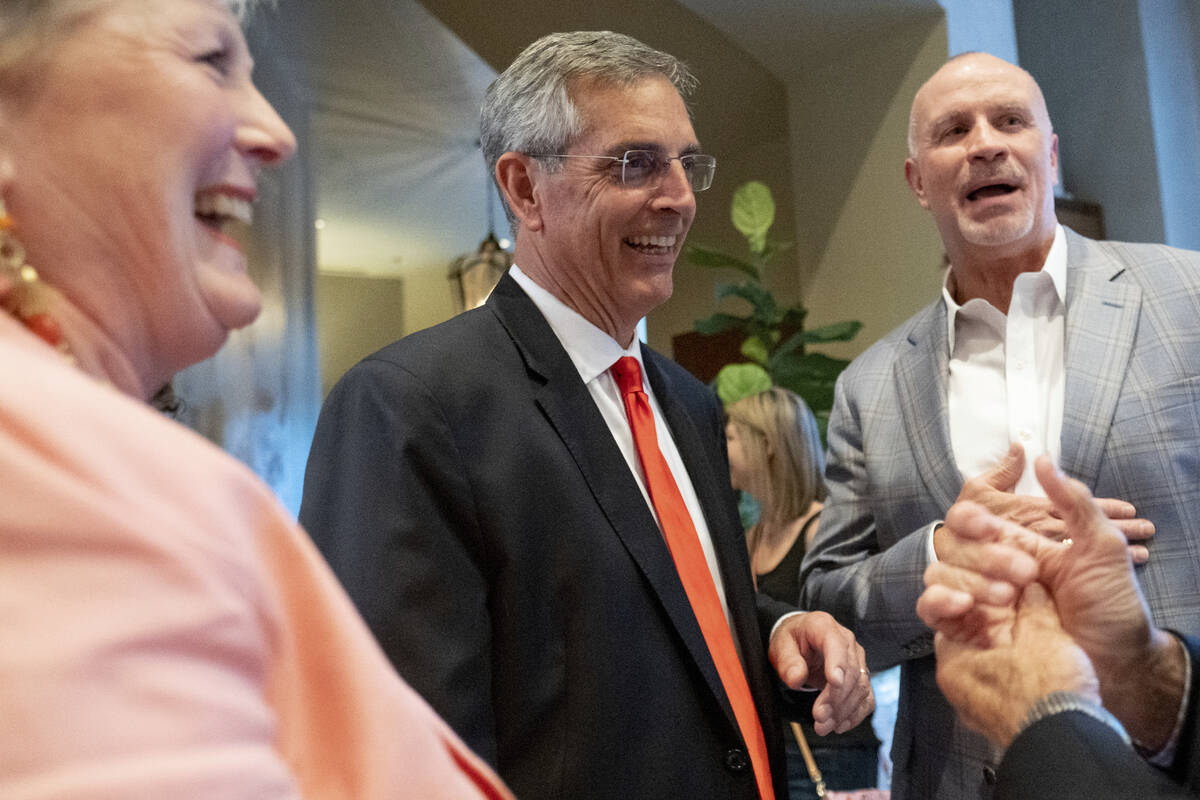 FILE - Incumbent Georgia Secretary of State Brad Raffensperger, center, and his wife Tricia arr ...