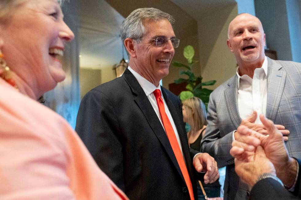 FILE - Incumbent Georgia Secretary of State Brad Raffensperger, center, and his wife Tricia arr ...