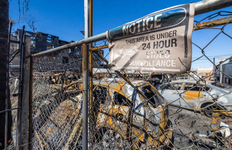 Burned out cars on the lot at Perfect Auto Body after a fire swept from stalled construction at ...