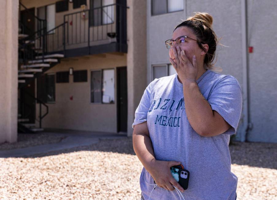 Kelly Suarez, a resident at the Ridge on Charleston Apartment complex, gets emotional as she sp ...